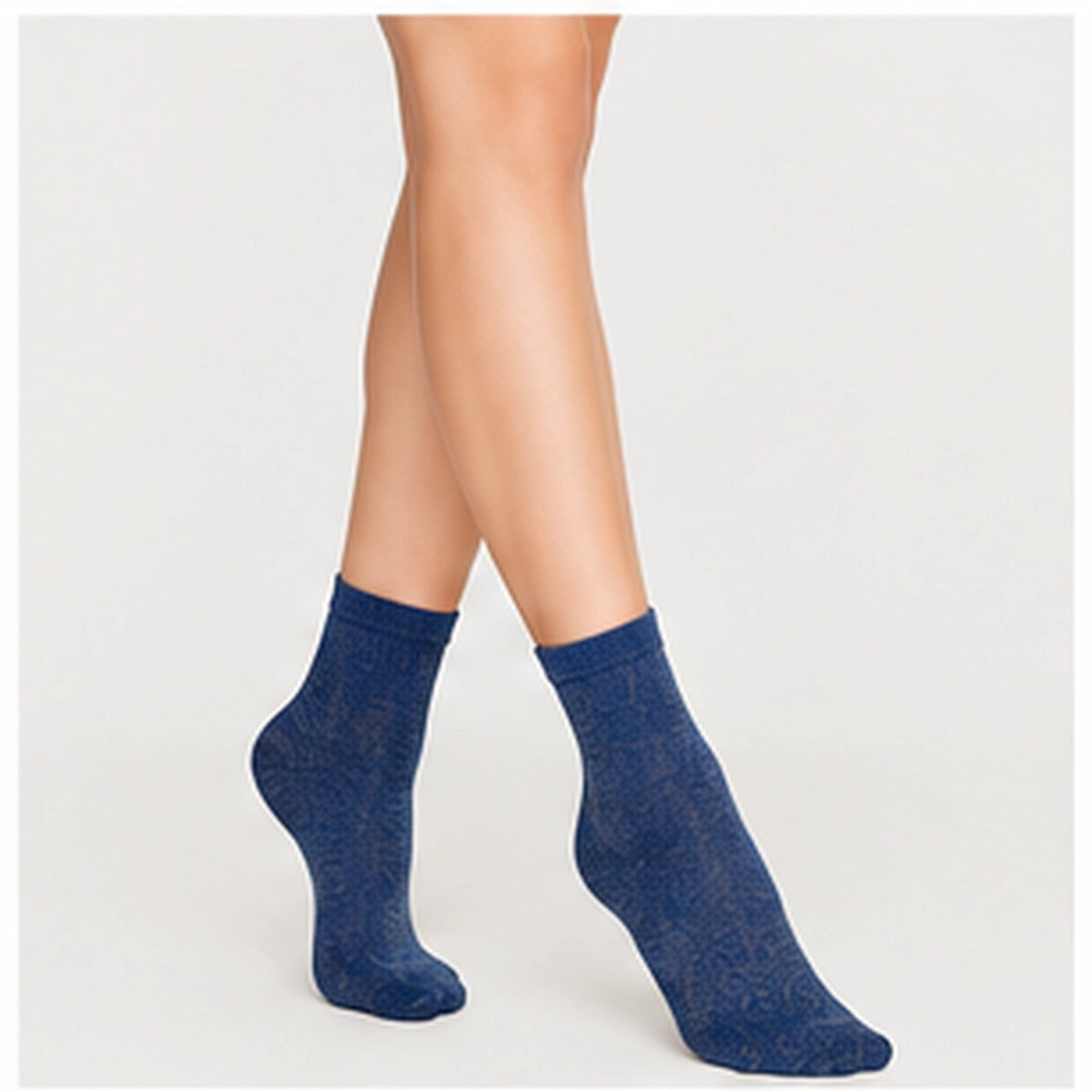 Woman wearing navy and gold, sparkly ankle sock
