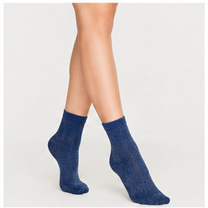 Woman wearing navy and gold, sparkly ankle sock