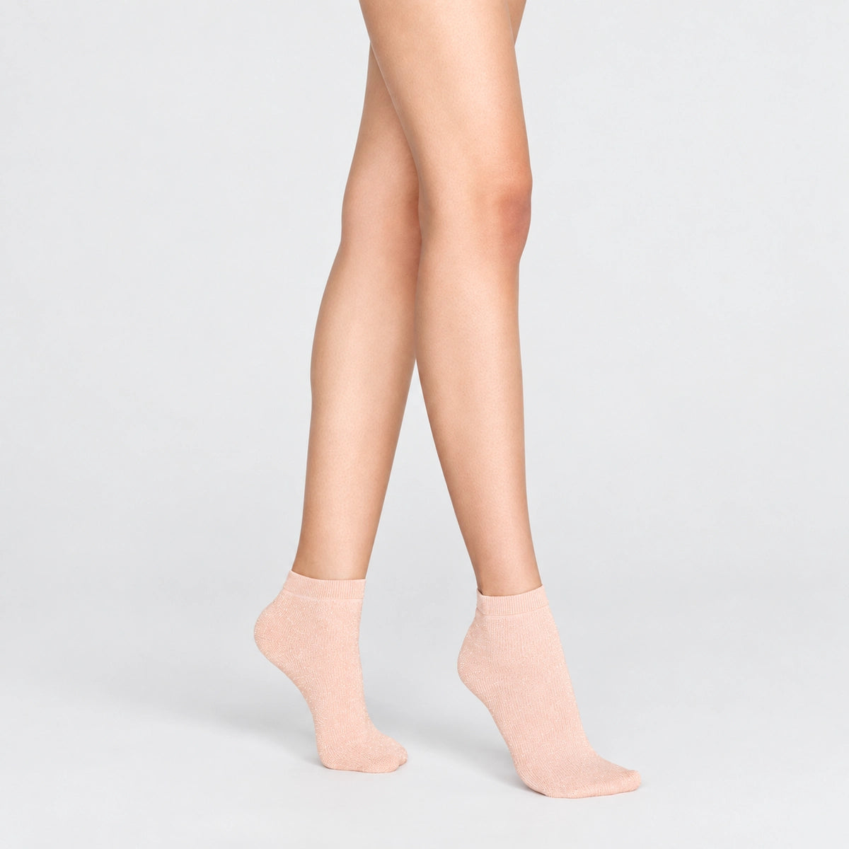 Woman wearing pink, sparkly ankle sock