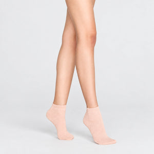 Woman wearing pink, sparkly ankle sock