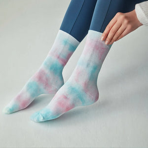 Person wearing washed blue and pink crew socks