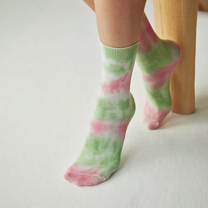 Person wearing washed green and pink crew socks