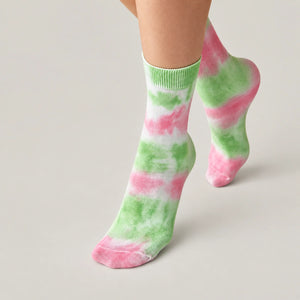 Person wearing washed green and pink crew socks