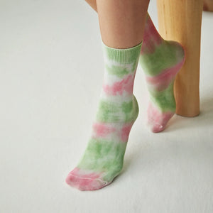 Person wearing washed green and pink crew socks