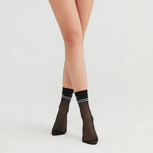 person wearing sheer black crew socks with striped cuff stating 'Love Myself'