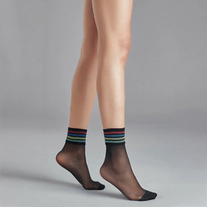 person wearing sheer black crew socks with multicoloured striped cuff