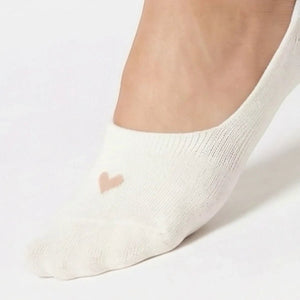 Cream no-show sock with a beige heart design on a light grey background