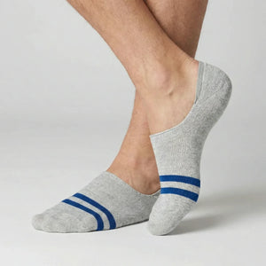 Grey no-show socks with blue stripes worn by a person on a light background
