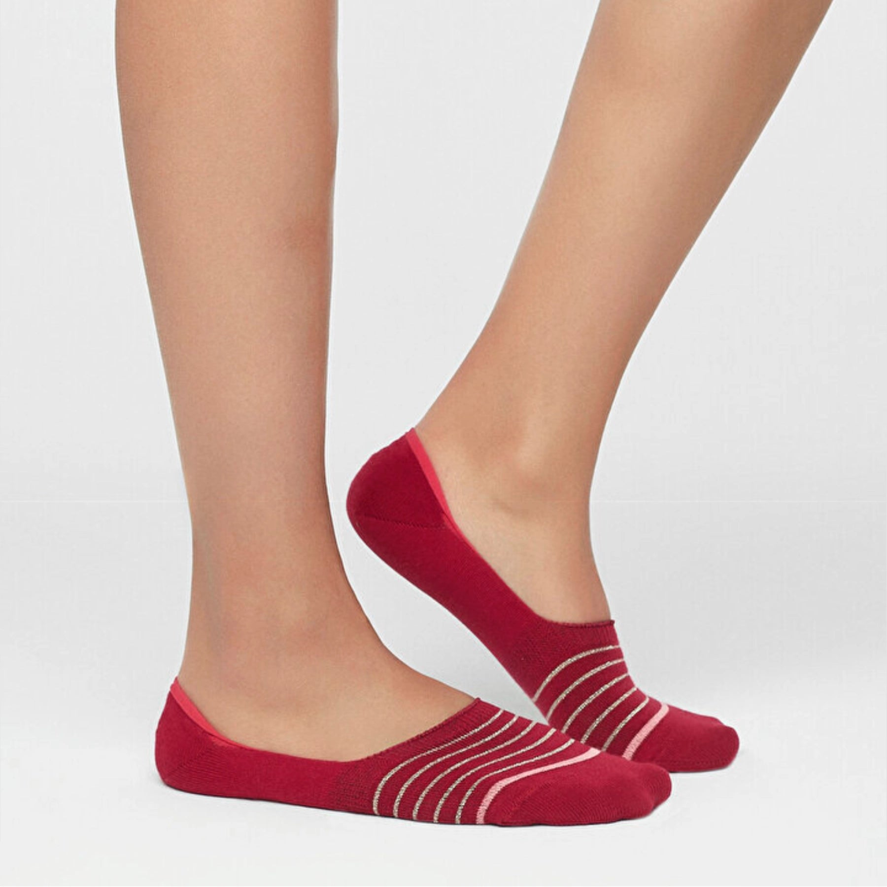 Person wearing red no-show socks with fine stripes