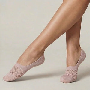 Rose no-show socks with open-weave design worn against a light background