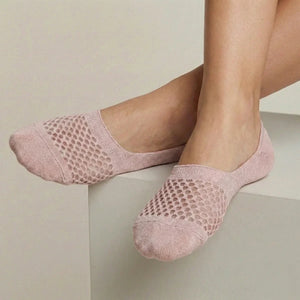 Rose no-show socks with open-weave design worn against a light background