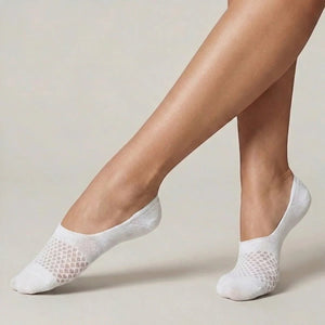 White no-show socks with open-weave design worn against a light background