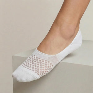 White no-show sock with open-weave design worn against a light background