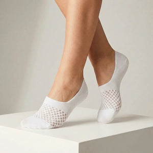 White no-show socks with open-weave design worn against a light background