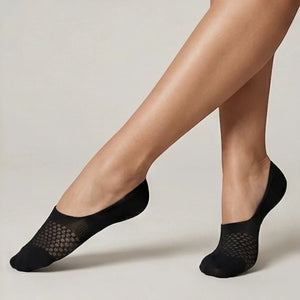 Black no-show socks with open-weave design worn against a light background