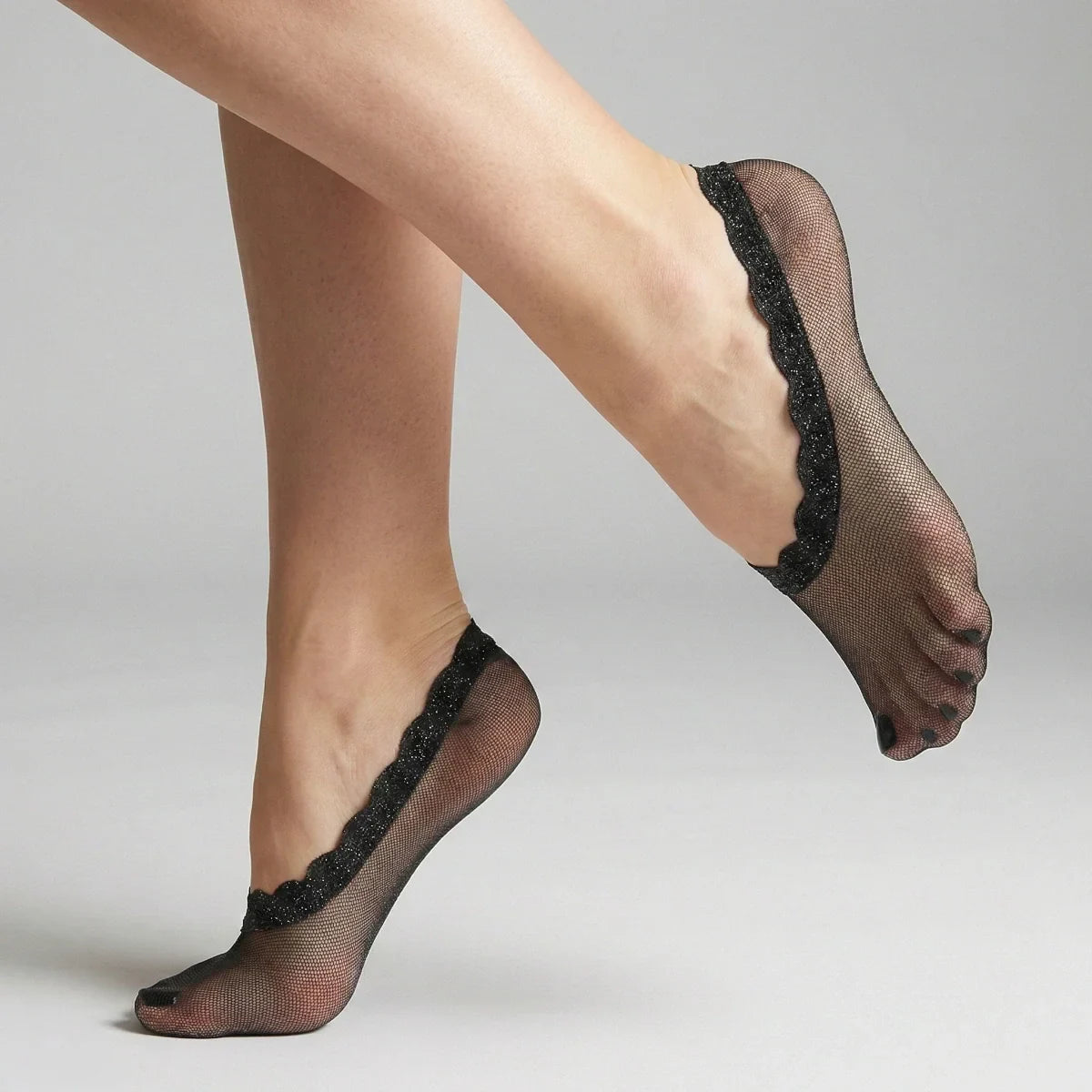 Navy sheer no-show socks with lace trim worn by a person on a neutral background