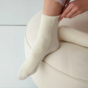 Woman wearing ivory socks with soft comfy front