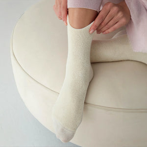 Woman wearing ivory socks with soft comfy front