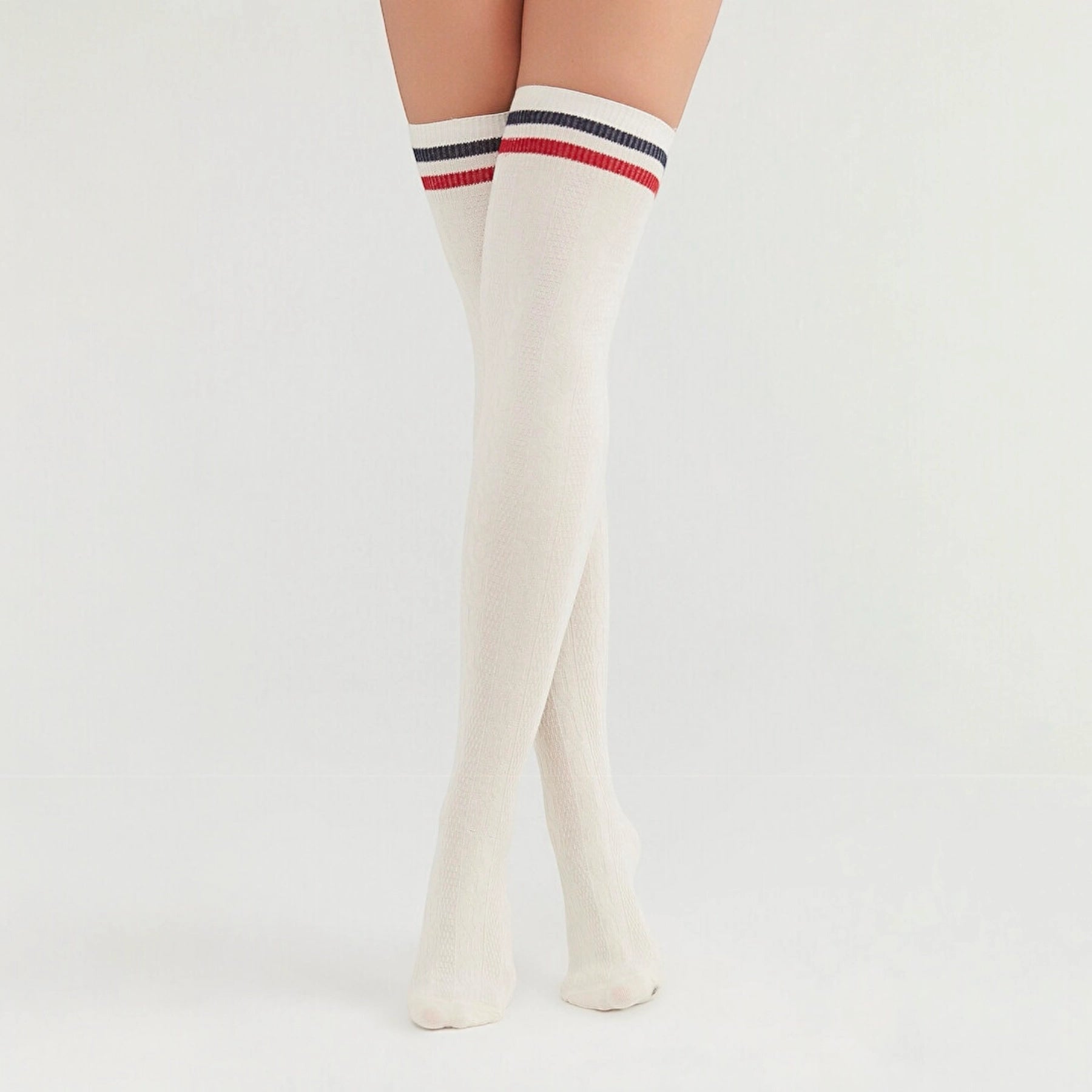 Woman wearing ivory coloured thigh-high socks with a black and a white stripe around the cuff