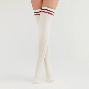 Woman wearing ivory coloured thigh-high socks with a black and a white stripe around the cuff