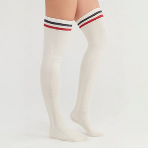 Woman wearing ivory coloured thigh-high socks with a black and a white stripe around the cuff