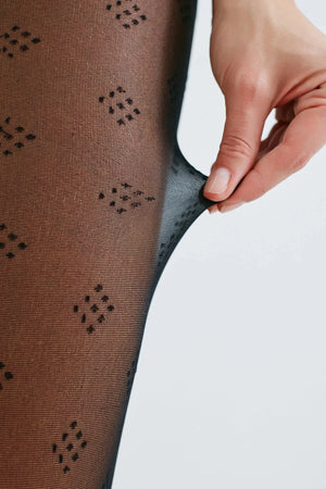 image of woman wearing black dice patterned pantyhose