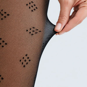 image of woman wearing black dice patterned pantyhose