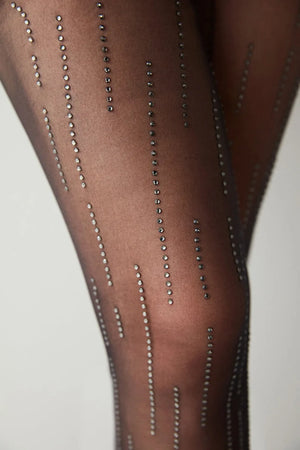 Black tights with rhinestone embellishments on a neutral background