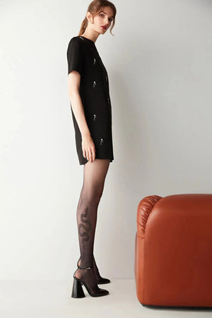 WModel wearing Uniq Socks premium sheer black tights with an elegant snake design on the calf.