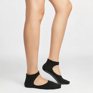 image of woman wearing black yoga socks