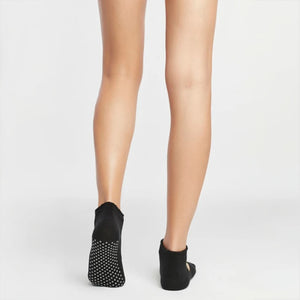 image of woman wearing black yoga socks