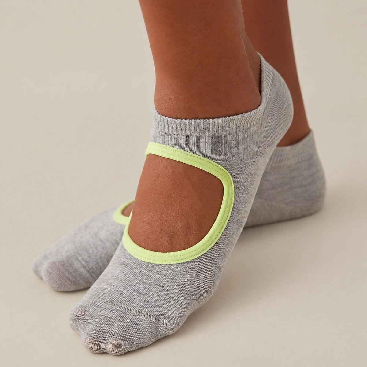 person wearing grey and yellow yoga socks