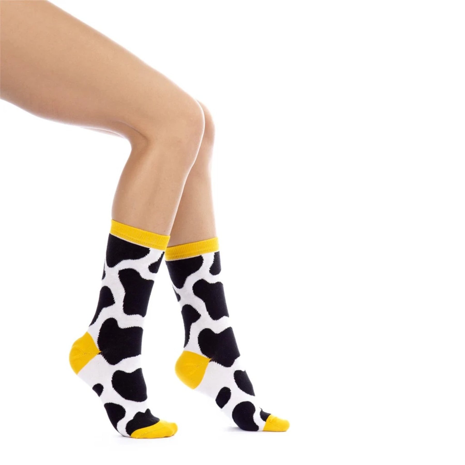 Woman wearing yellow cow themed socks
