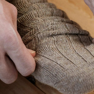 Person wearing beige alpaca and merino wool socks