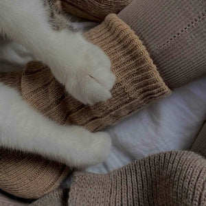 Person wearing beige alpaca and merino wool socks