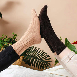 Person wearing beige and a person wearing brown alpaca and merino wool socks