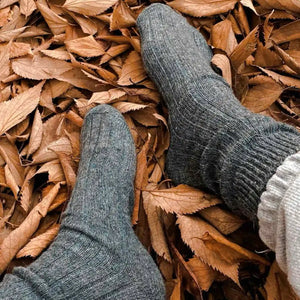 Person wearing grey alpaca and merino wool socks
