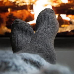 Person wearing charcoal alpaca and merino wool socks