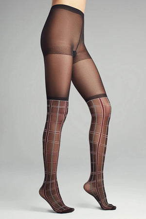 image of woman wearing black patterned tartan tights