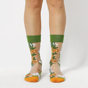 image of person wearing sheer socks with plant detail