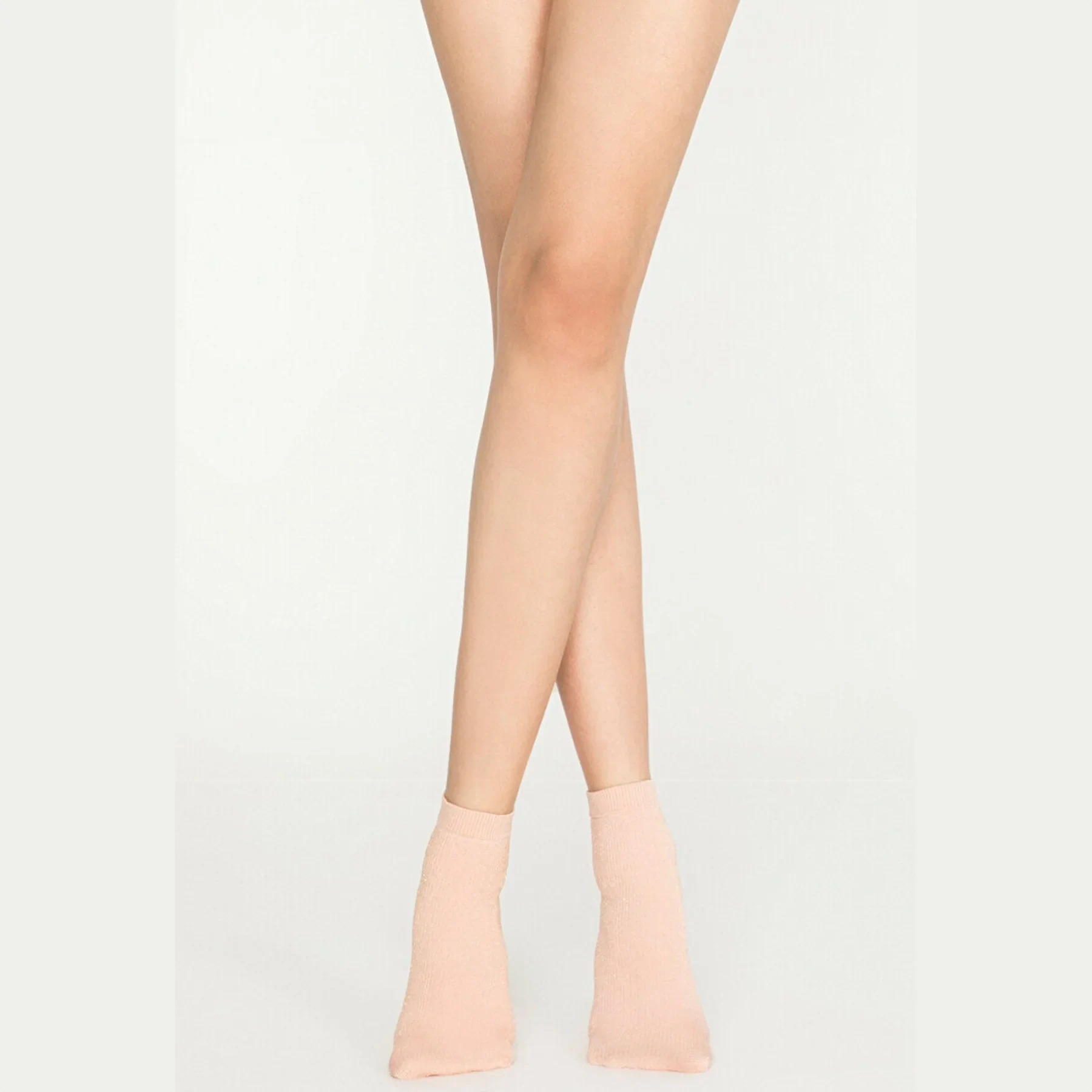 Woman wearing pink gold sparkle ankle socks