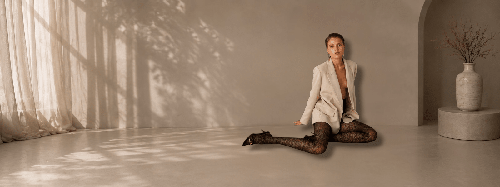 Luxury women’s patterned tights styled with black heels in a premium editorial fashion studio.