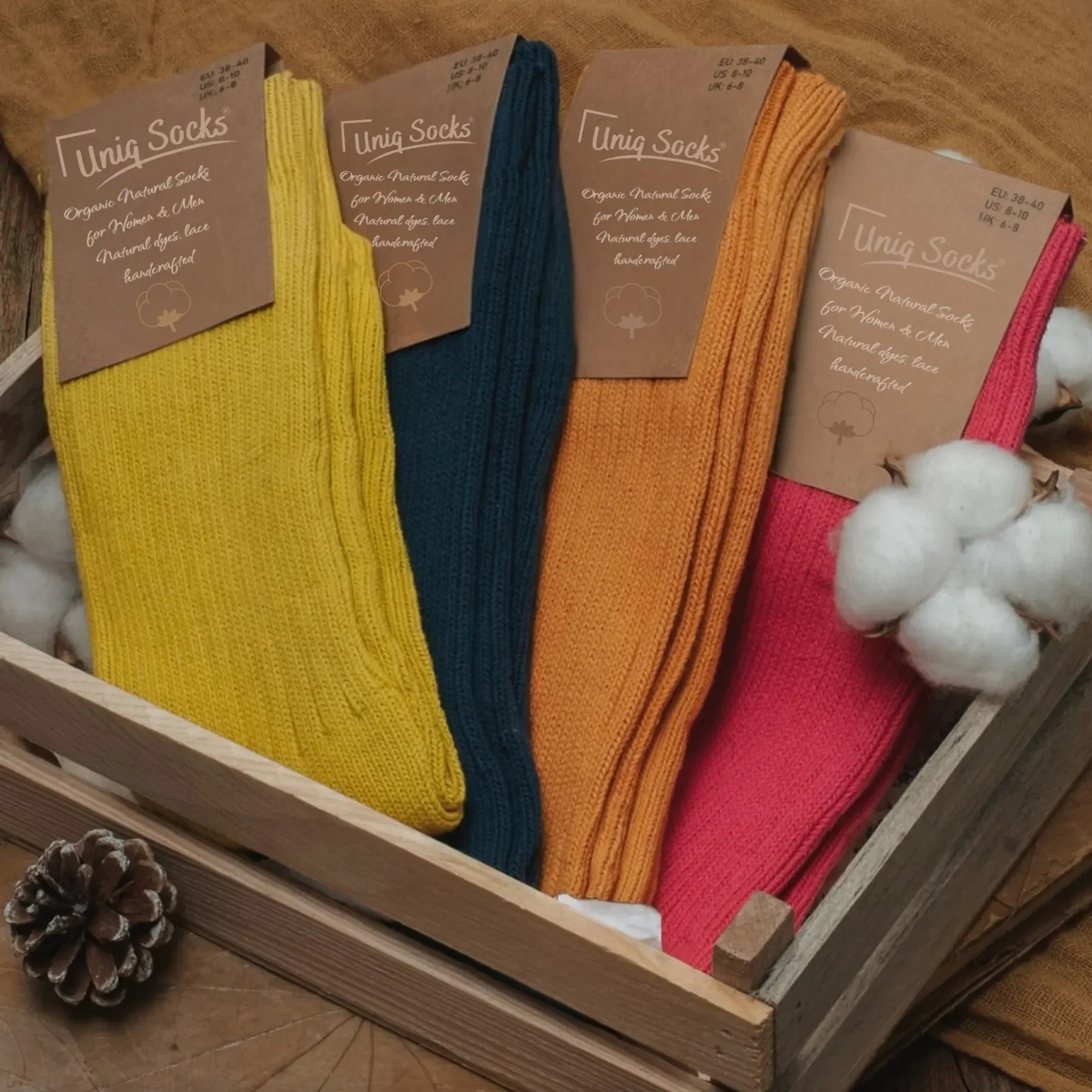 Four options of plain, bright coloured socks in a timber box