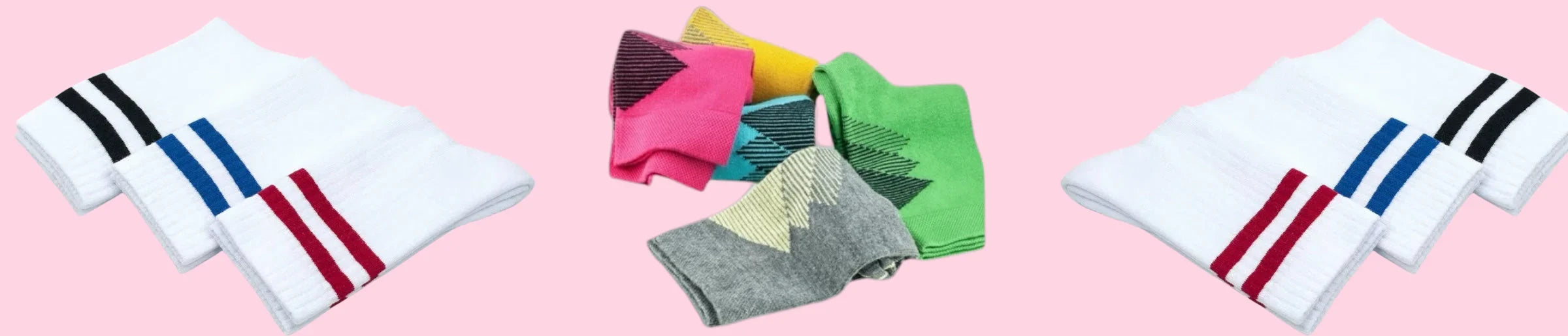 A selection of bright coloured socks and traditional white tennis socks against a pink background