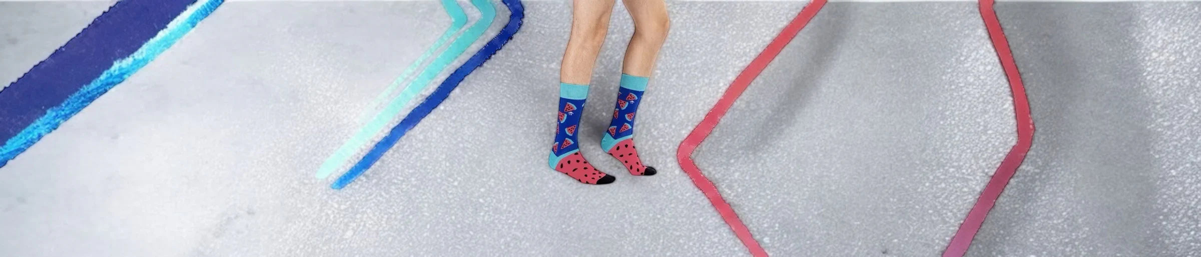 A person wearing blue and pink themed crew socks against a grey background