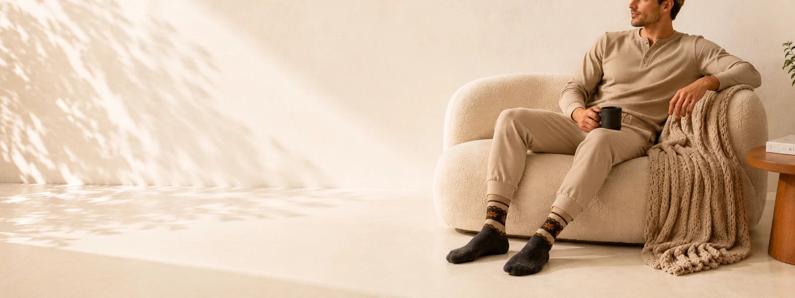 Man sitting on a lounge in a living room wearing socks