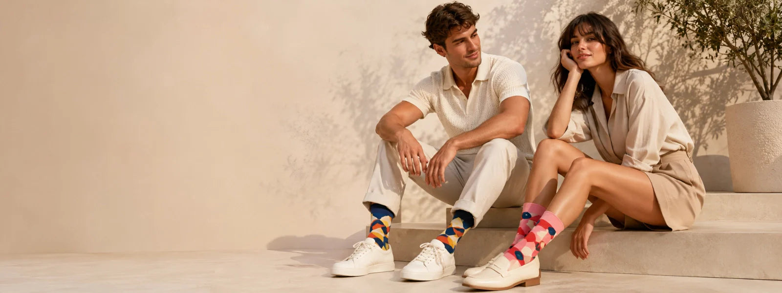 Man and woman wearing colourful patterned socks in a premium lifestyle setting | Uniq Socks Australia