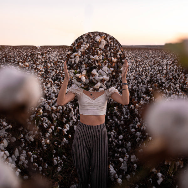 image of a woman standing in the middle of cotton fields