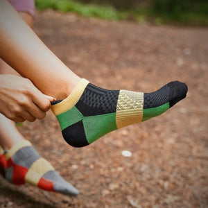 Person wearing bamboo green athletic sneaker sock with heel tab