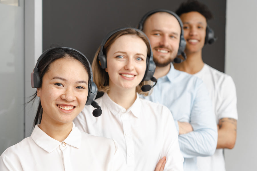 image of four customer service people with headsets on